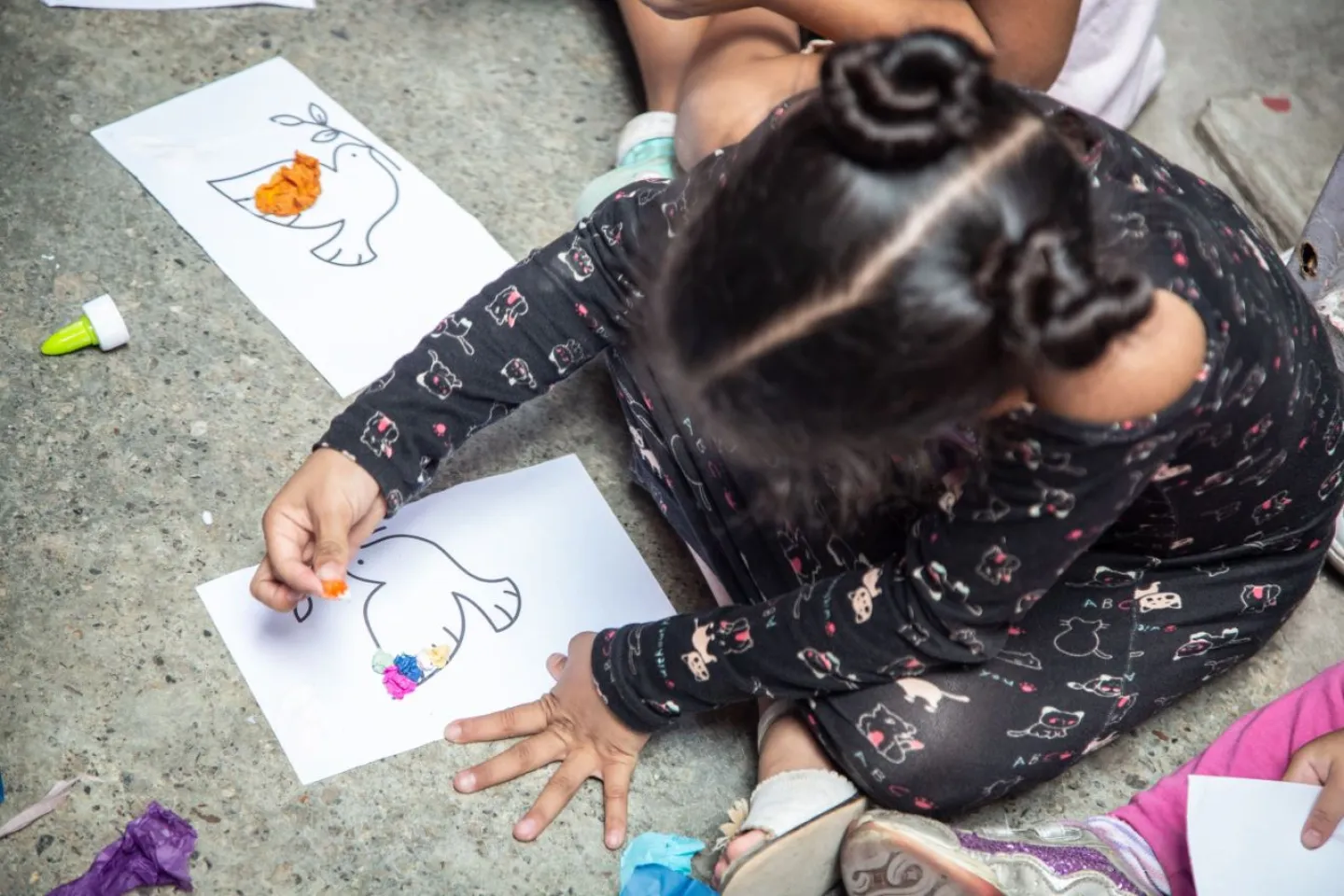 Una ni&ntilde;a dibuja sobre una hoja de papel blanco.