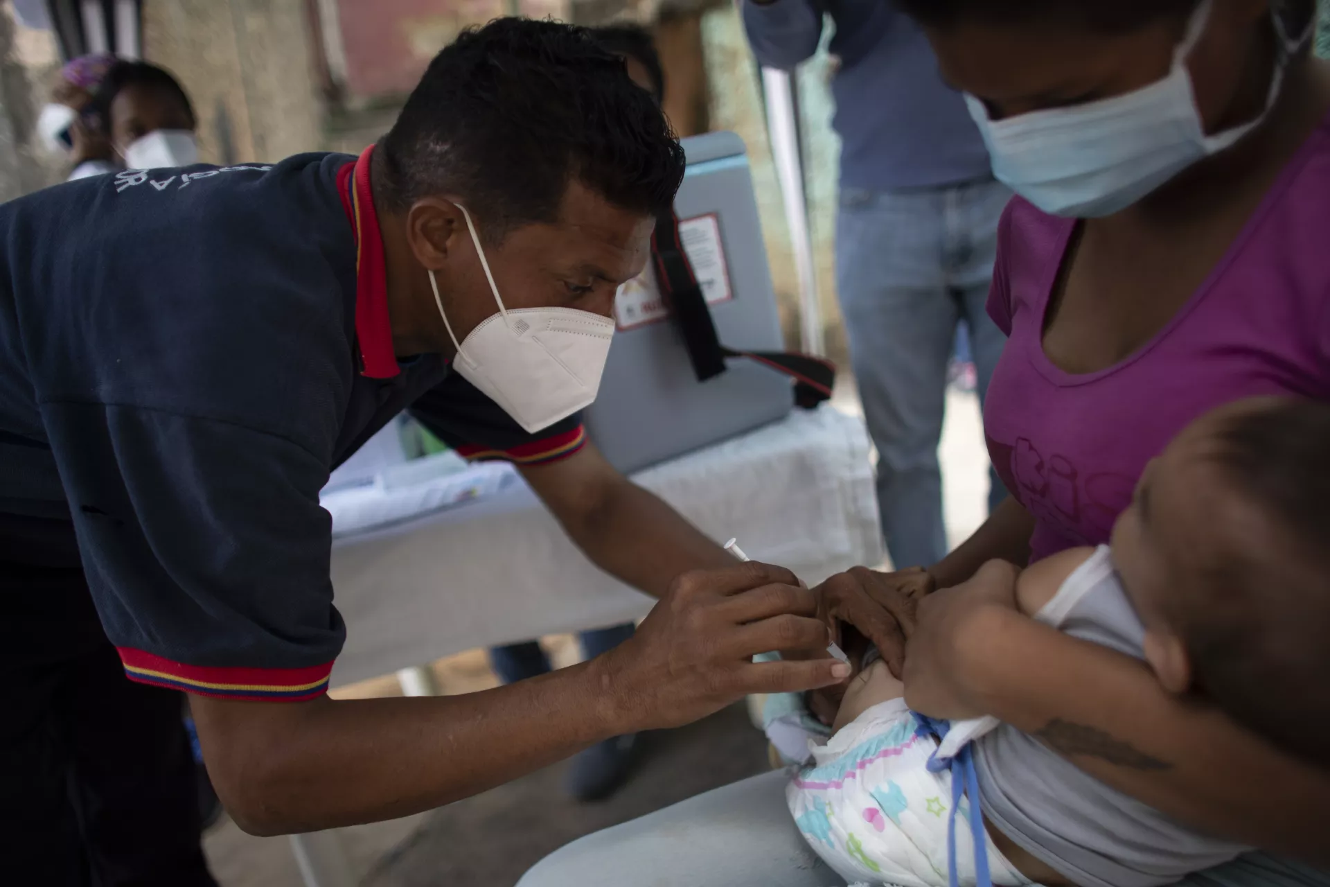 A 9-month-old boy is vaccinated during a UNICEF-supported mass vaccination drive.
