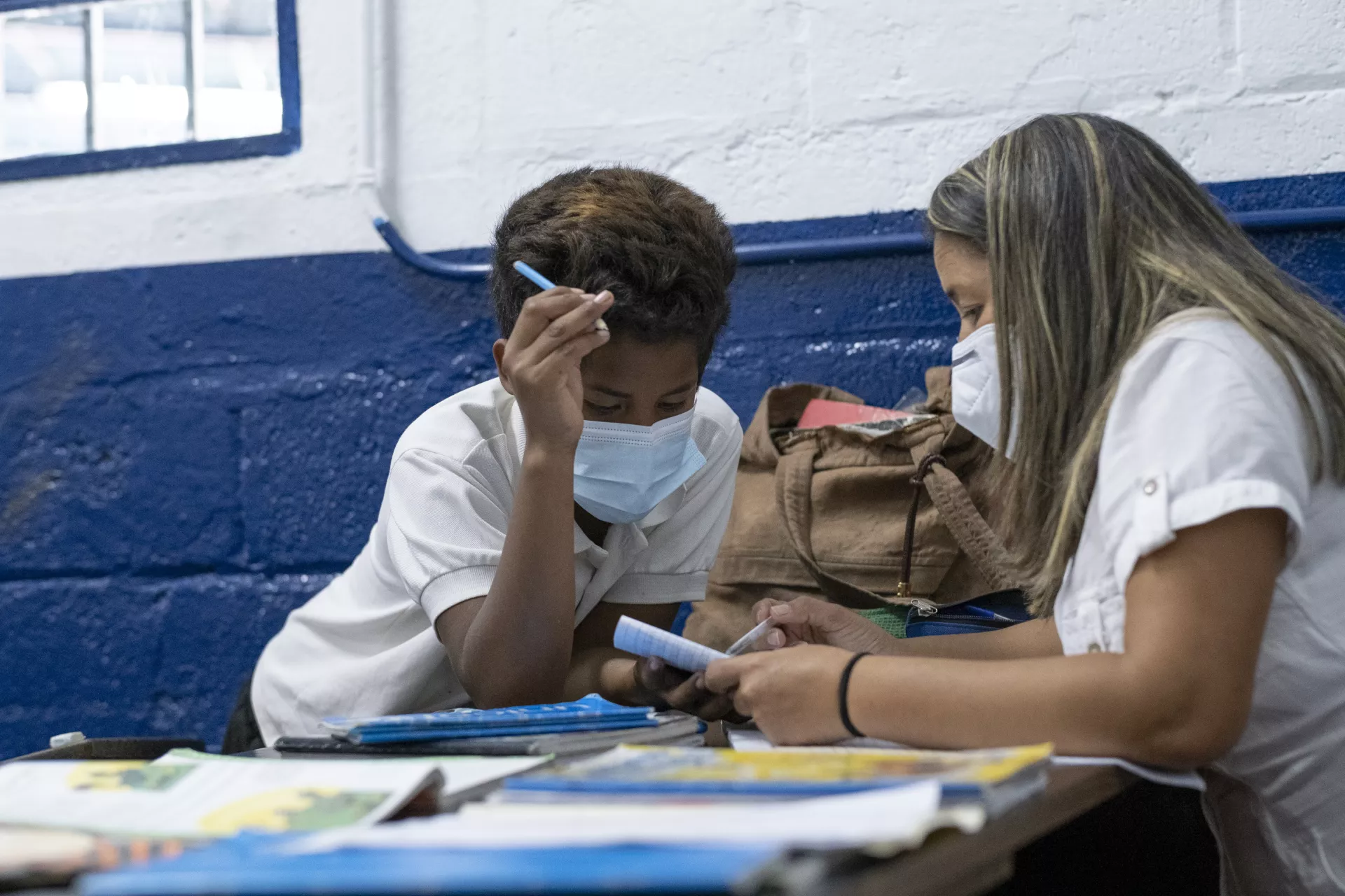 Abraham and his 6-grade teacher review his language homework