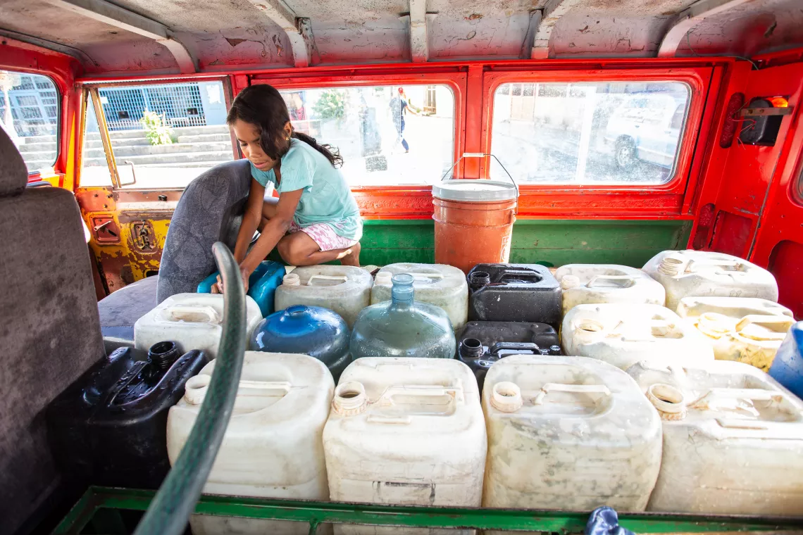 9-year-old Duglianis Gonz&aacute;lez S&aacute;nchez fills up with water a jerry can in the community of Petare, Caracas, Venezuela. 9-year-old Duglianis Gonz&aacute;lez S&aacute;nchez fills up with water a jerry can in the community of Petare, Caracas, Venezuela.