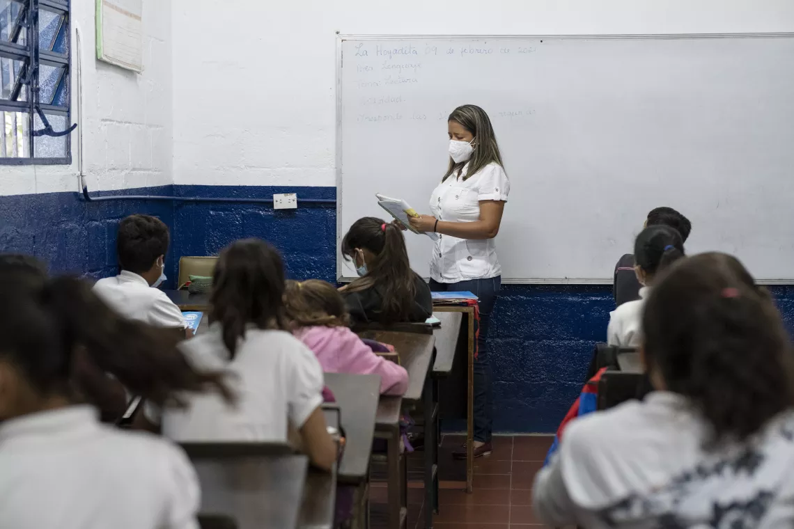 In Abraham's classroom, the teacher dictates homework.