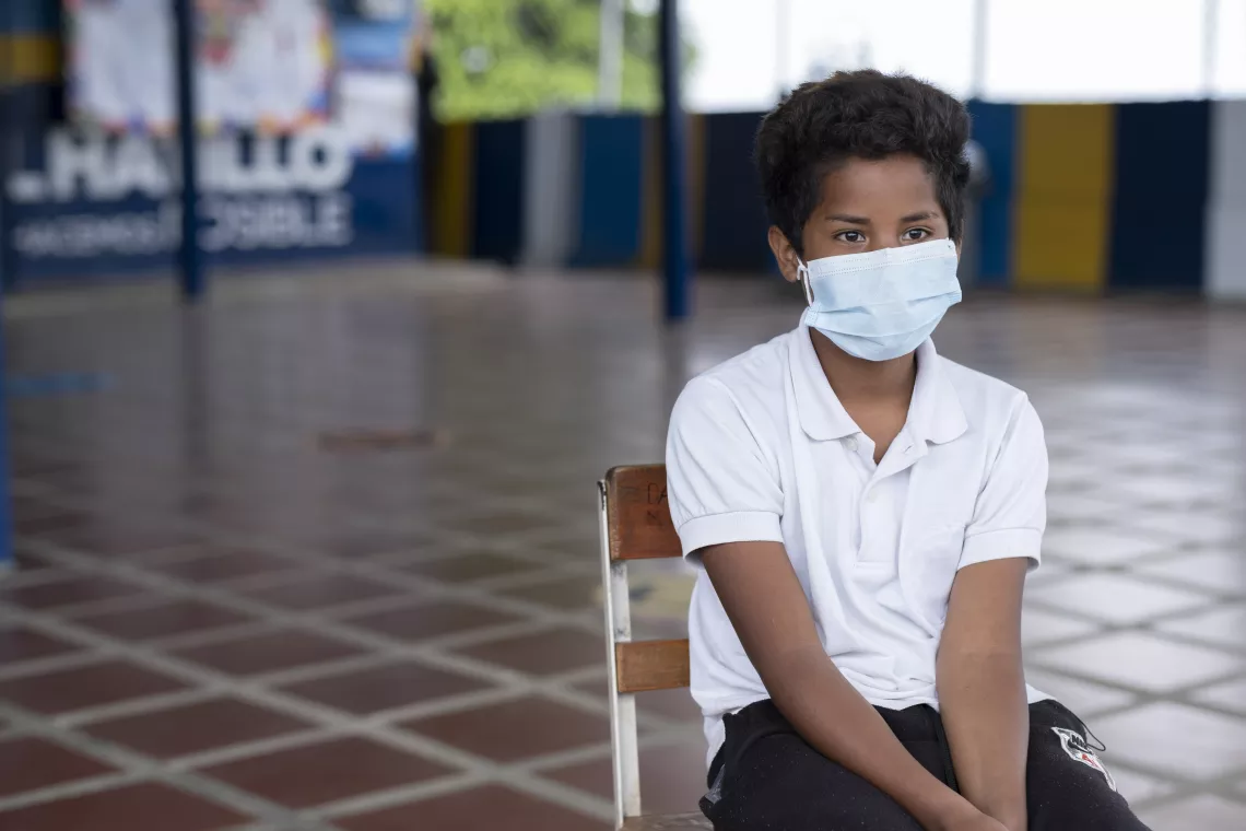 Abraham in his schoolyard talks about what he likes most about going to class.