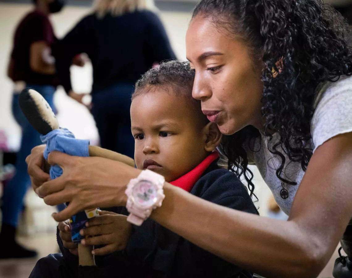 A boy and his mother, during the practical activities of the Care for Child Development programme. San Agustin community, Caracas, Venezuela 14 March 2023.