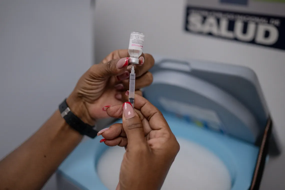 A health worker prepares a vaccine during a UNICEF-supported health outreach session in Santa Luc&iacute;a del Tuy, Miranda State, Venezuela.