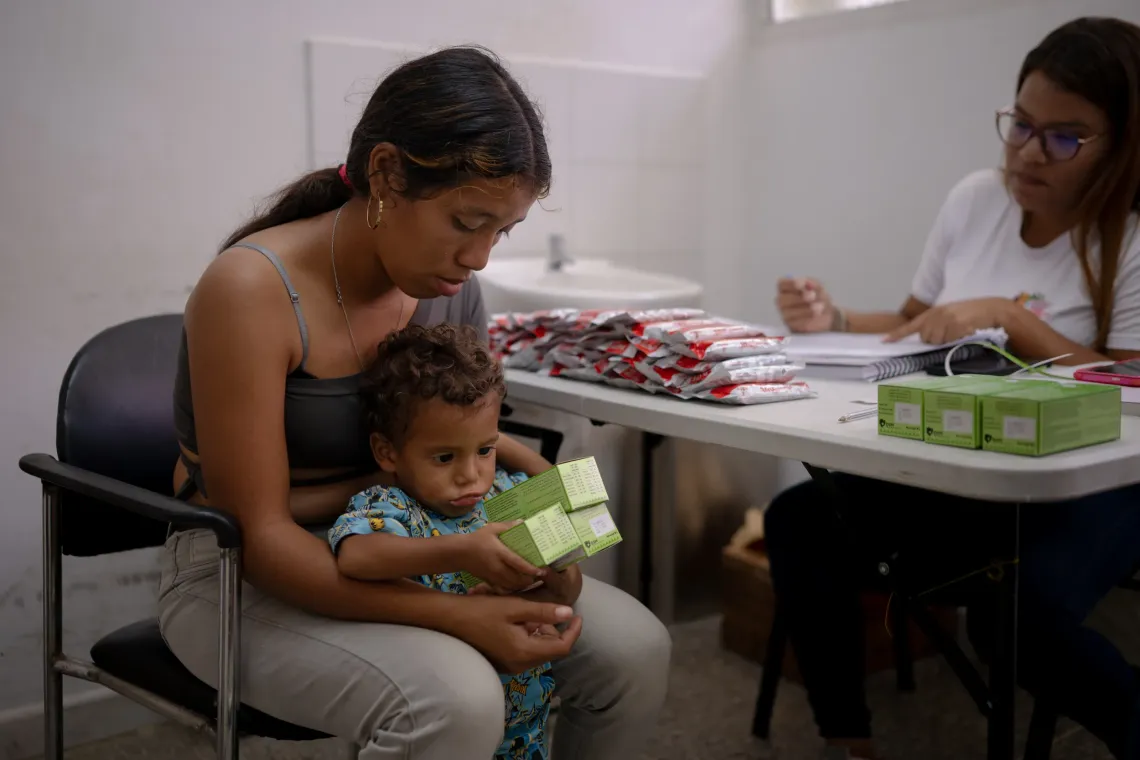 A health worker speaks with a mother holding her child during a nutrition consultation in Santa Luc&iacute;a del Tuy, Miranda State, Venezuela.