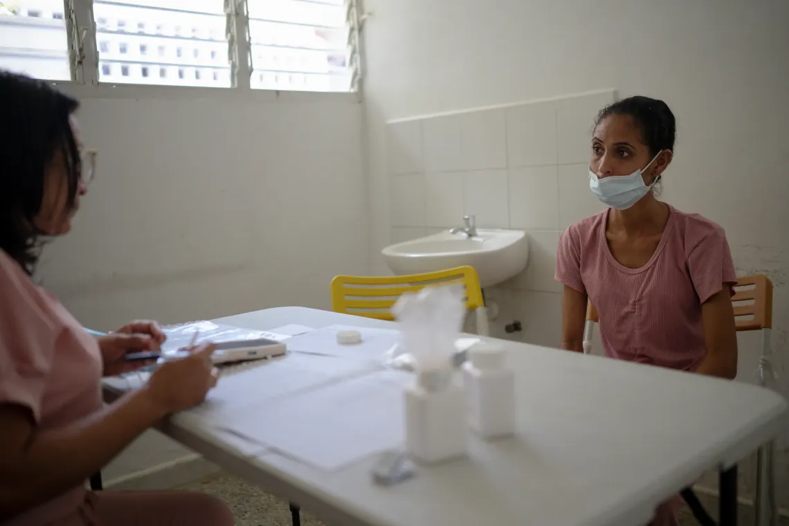 Elys Rodr&iacute;guez, 31, speaks with a health worker during a consultation in Santa Luc&iacute;a del Tuy, Miranda State, Venezuela.