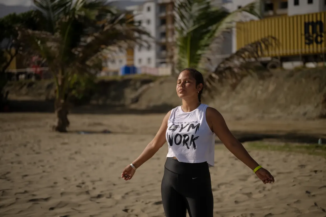 Mercedes, Dami&aacute;n&rsquo;s aunt, takes a moment for herself on a beach in La Guaira. Walking by the sea and practising breathing exercises help her find calm.