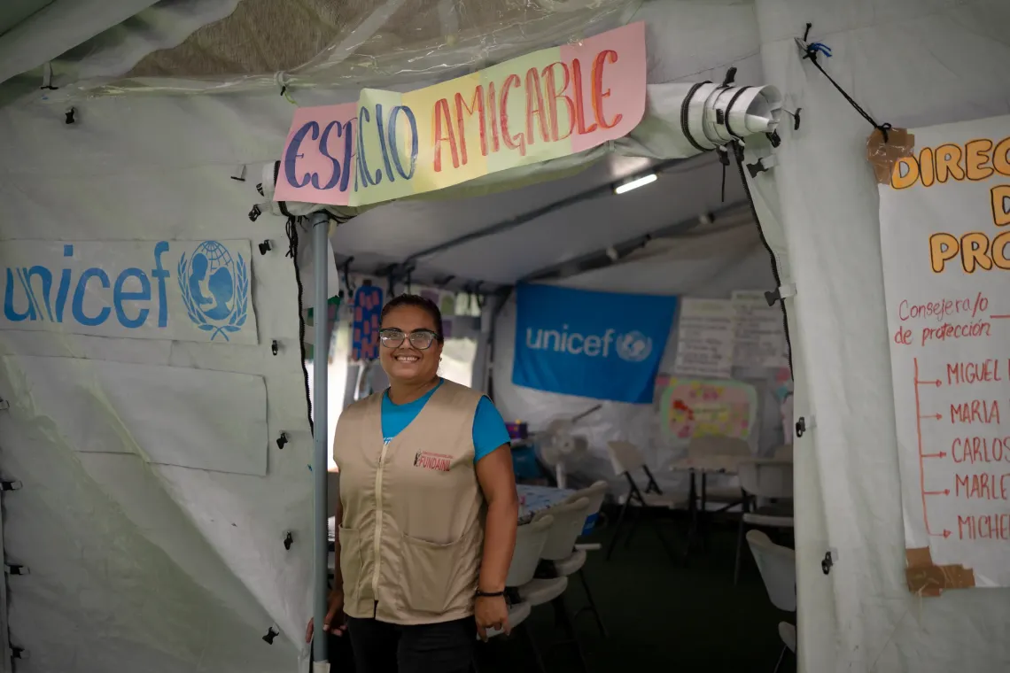 Aracely David, a social worker and child protection specialist with Fundainil, at the entrance to the UNICEF-supported child-friendly space at the Jos&eacute; Mar&iacute;a Vargas sports complex camp in La Guaira.