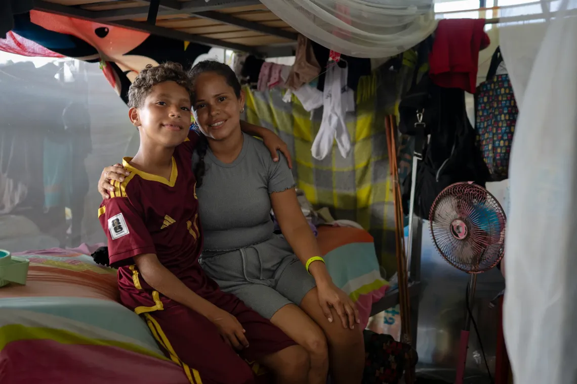 Dami&aacute;n, 13, with his aunt Mercedes, who took him into her care after his mother died in the June earthquakes, at the temporary camp in the Jos&eacute; Mar&iacute;a Vargas sports complex in La Guaira.