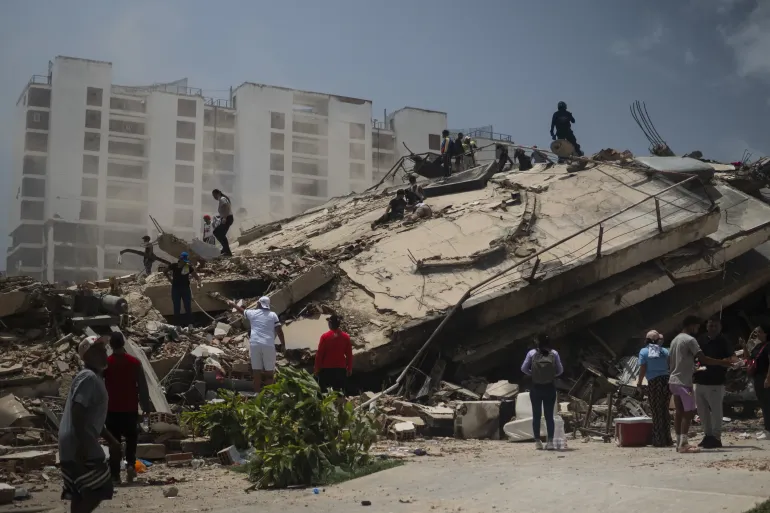 On 26 June 2026, groups search through rubble in the state of La Guaira, Venezuela, after two major earthquakes on 24 June caused homes and buildings to collapse. Thousands remain unaccounted for, and many may still be searching for loved ones trapped beneath the debris.
