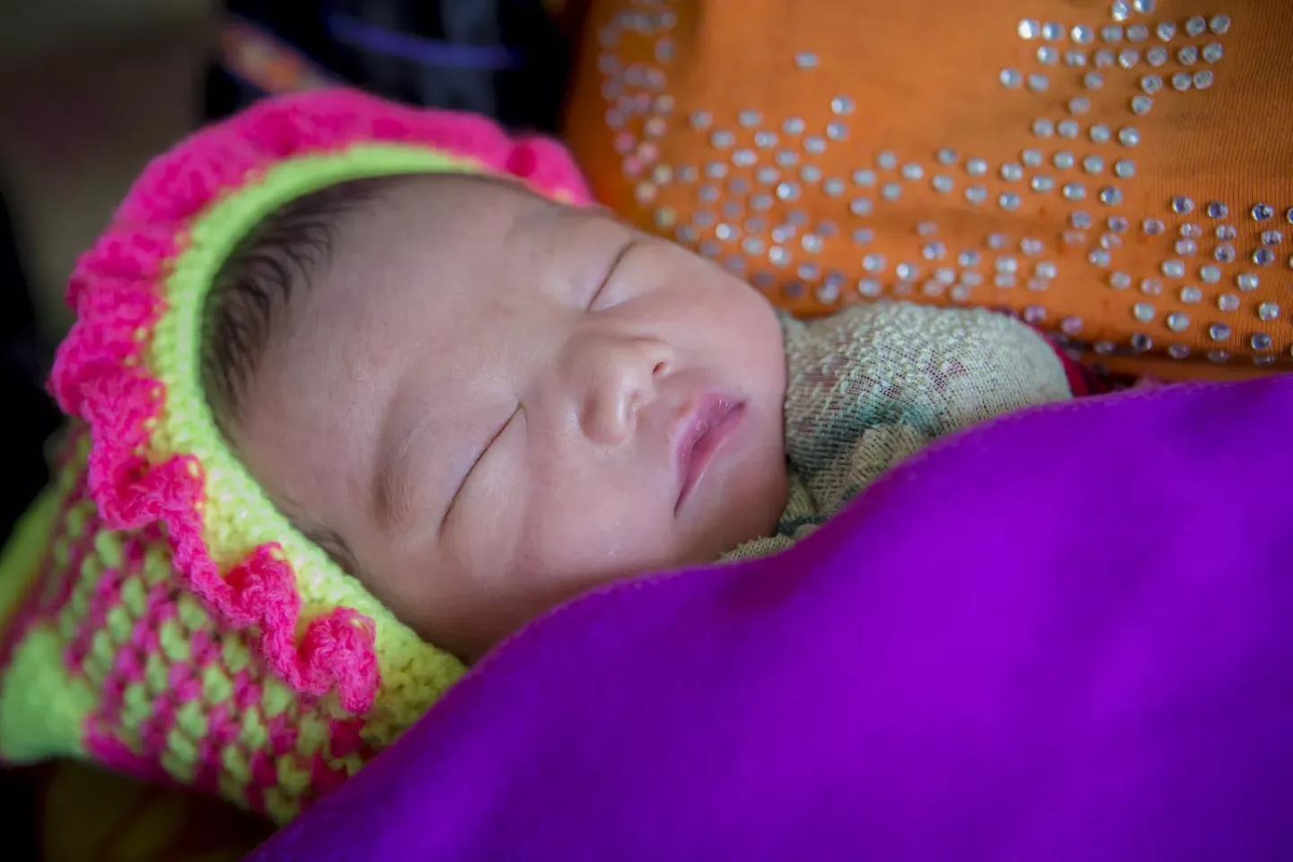 An infant in their mother's arm