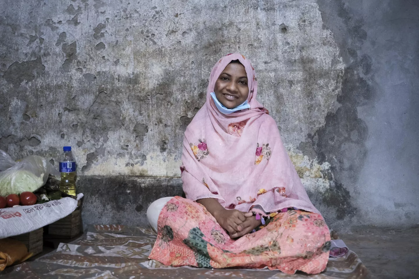 Alia, 17, sits for a portrait in the home she shares with her sister in Dhaka, Bangladesh. By age 17, Alia had already experienced significant loss and instability in her life.  When she was 9, her mother died, and her father remarried. When she was 16, her father died, leaving Alia to care for her younger sister.