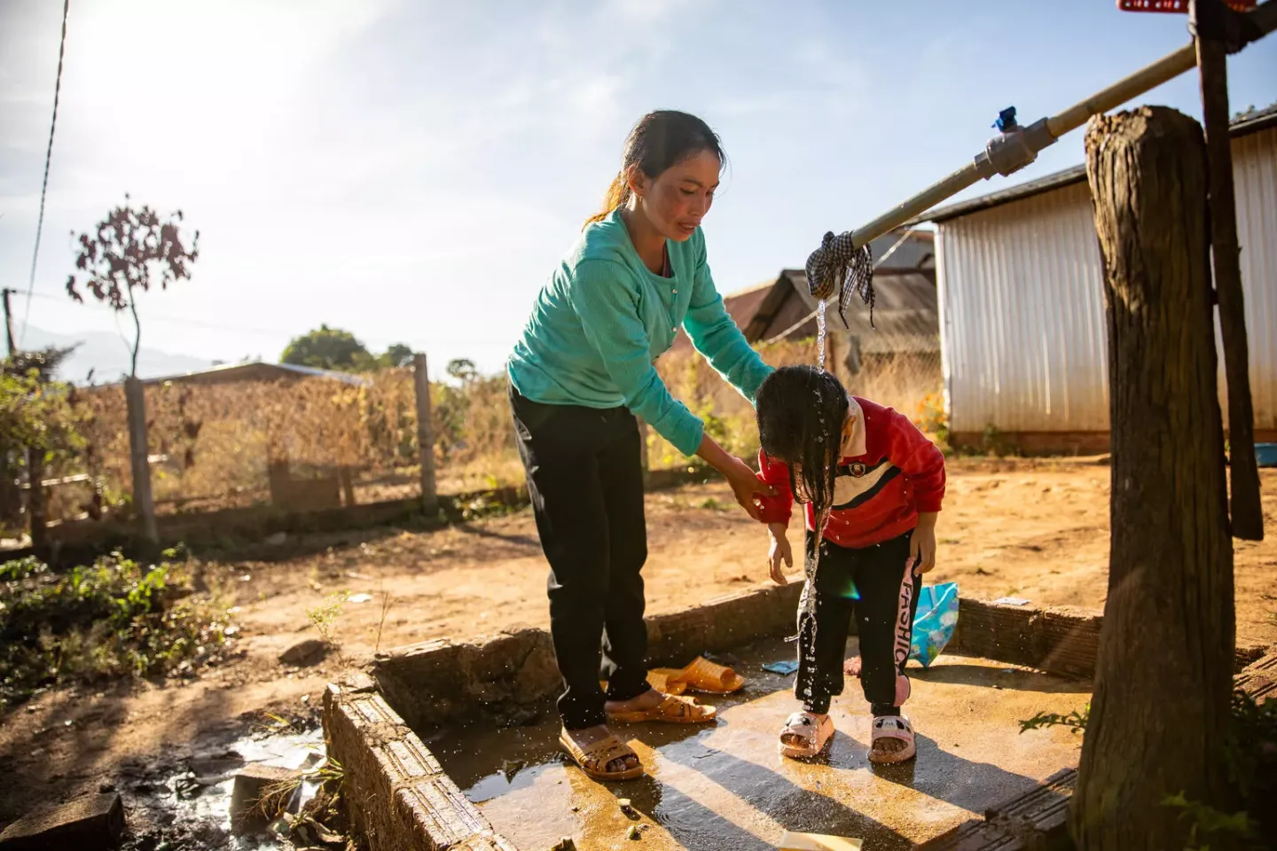 Mother washes hair for her daughter