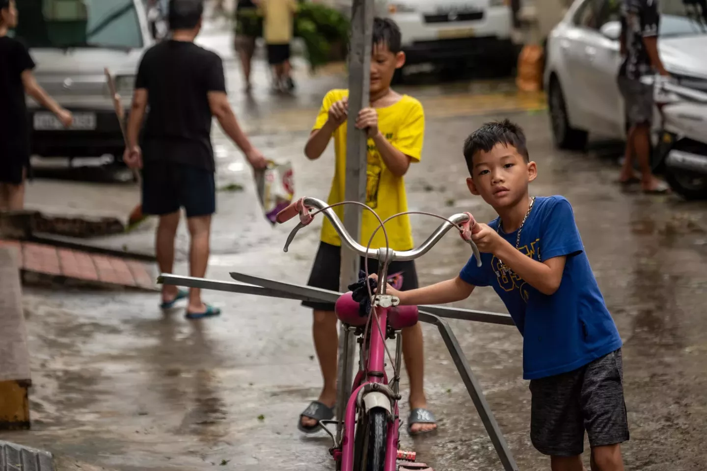 Vũ T&ugrave;ng L&acirc;m (front), 8, and Vũ C&ocirc;ng Dũng (back), 10, return home after Typhoon Yagi on September 8, 2024, in Cam Pha, Quang Ninh Province, Viet Nam.