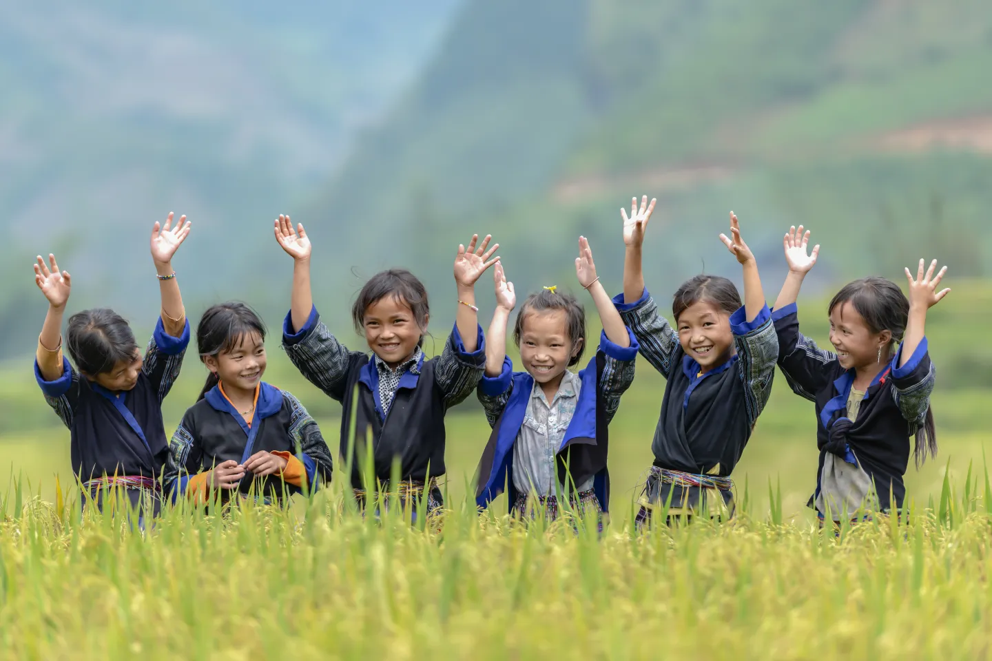 A group of ethnic girls in the rural areas of Viet Nam singing and dancing in the rice terraces area in their neighborhood at Mu Cang Chai, Yen Bai, Viet Nam.