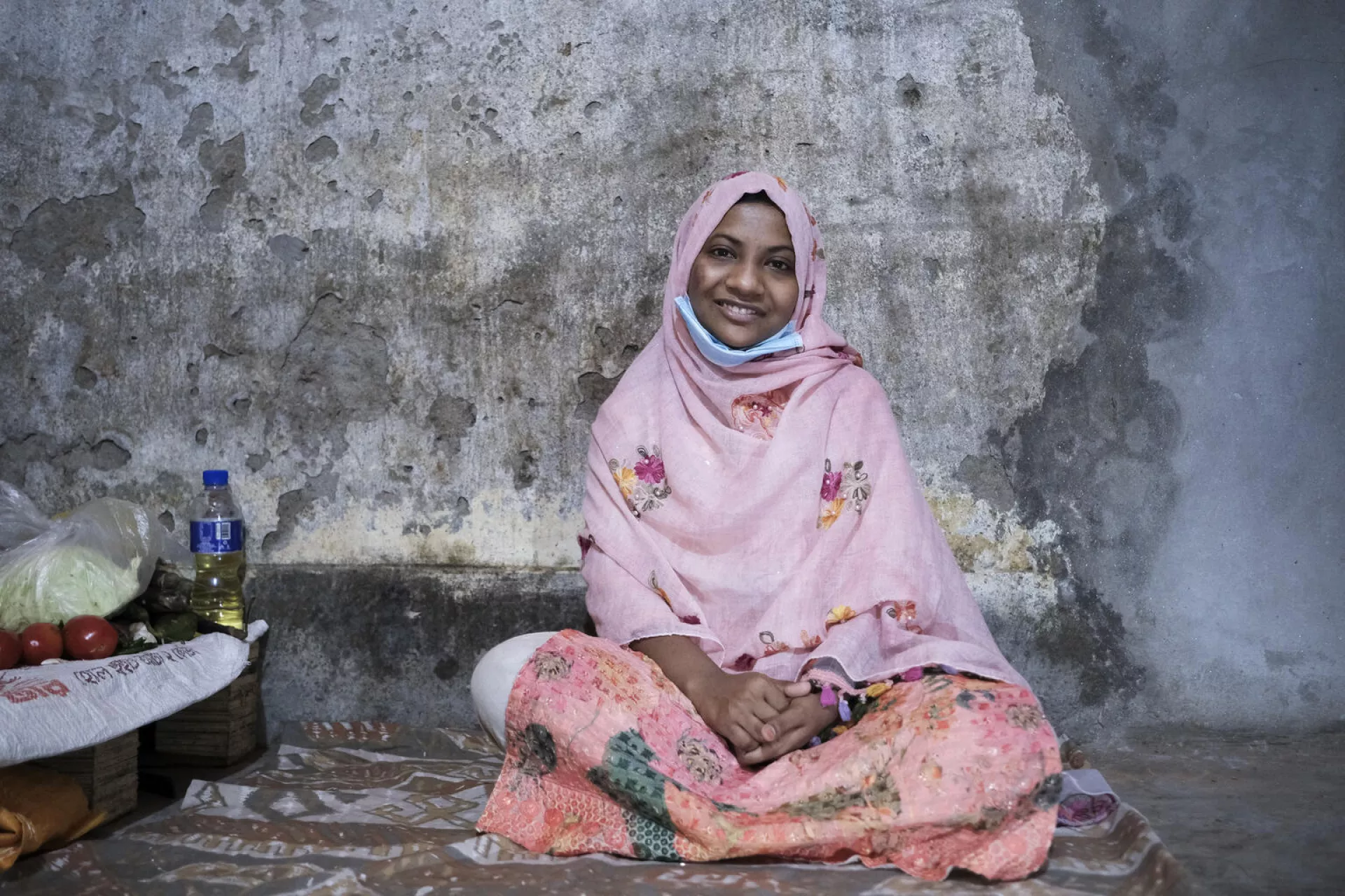Alia, 17, sits for a portrait in the home she shares with her sister in Dhaka, Bangladesh. By age 17, Alia had already experienced significant loss and instability in her life.  When she was 9, her mother died, and her father remarried. When she was 16, her father died, leaving Alia to care for her younger sister.