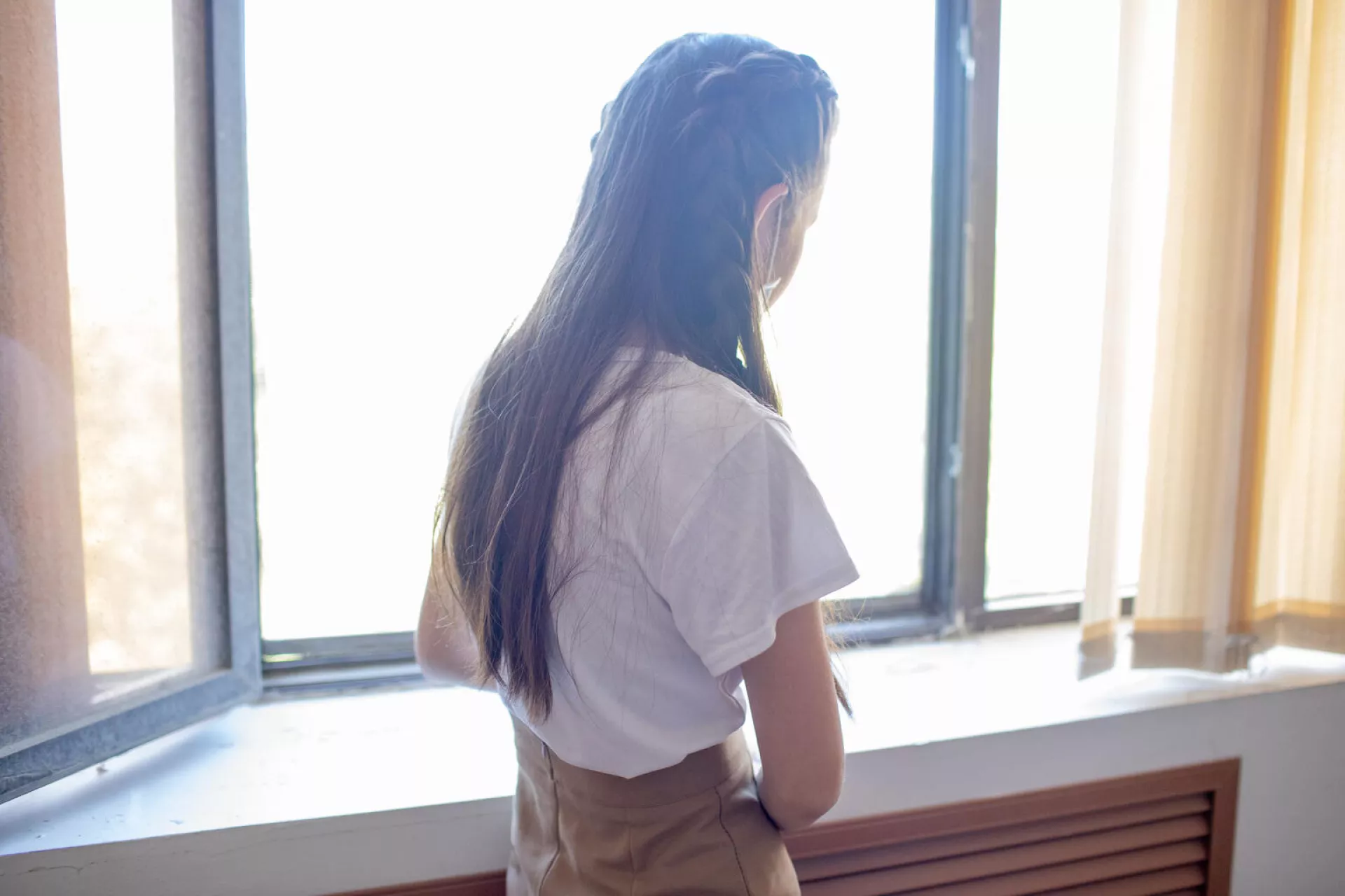  Dina, 14, stands by a window at the Bilim Foundation in Kyzylorda, Kazakhstan.
