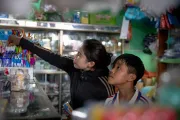 Lan and her 10-year-old son, Khoi, pick out new notebooks and pens for the upcoming school year. Through multi-purpose cash assistance, families are empowered to decide how best to meet their own needs with dignity, flexibility, and choice.