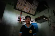 10-year-old Khoi proudly displays his sports medal and certificates