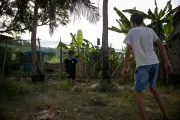 Ten-year-old Khoi plays soccer with a neighbor in front of his house.