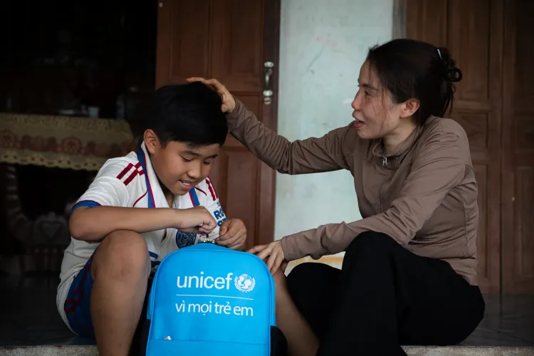Ho Thi My Lan and her son Nguyen Dang Khoi, 10, in Xuan Tho commune, Dak Lak province, which was impacted by Typhoon No. 13 in 2025.