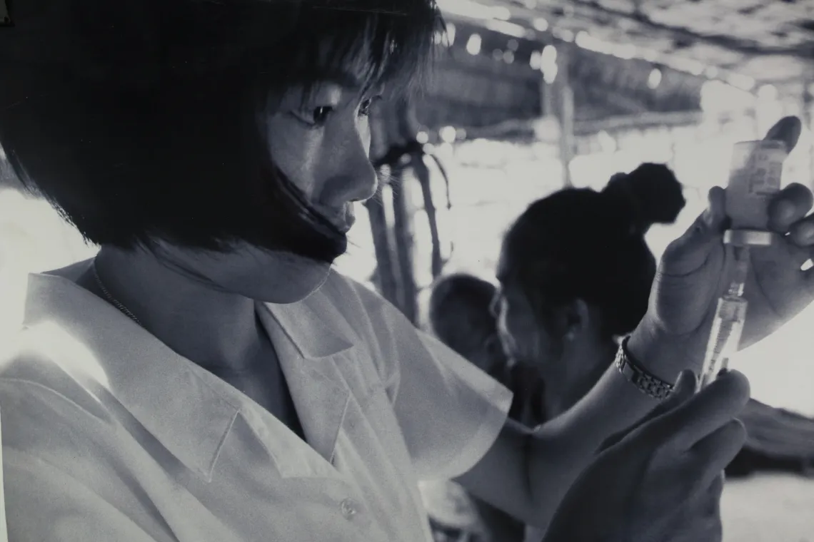 A health worker vaccinating children on a boat in the Mekong Delta, 1999.