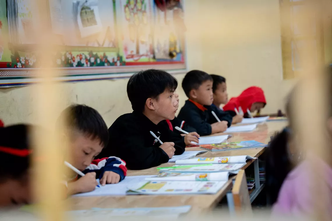 Thao Seo Ha takes notes during his class.