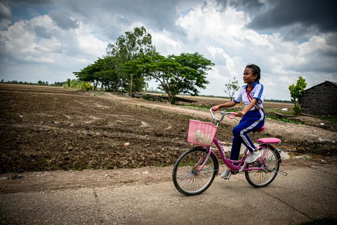 A girl rides a bicycle