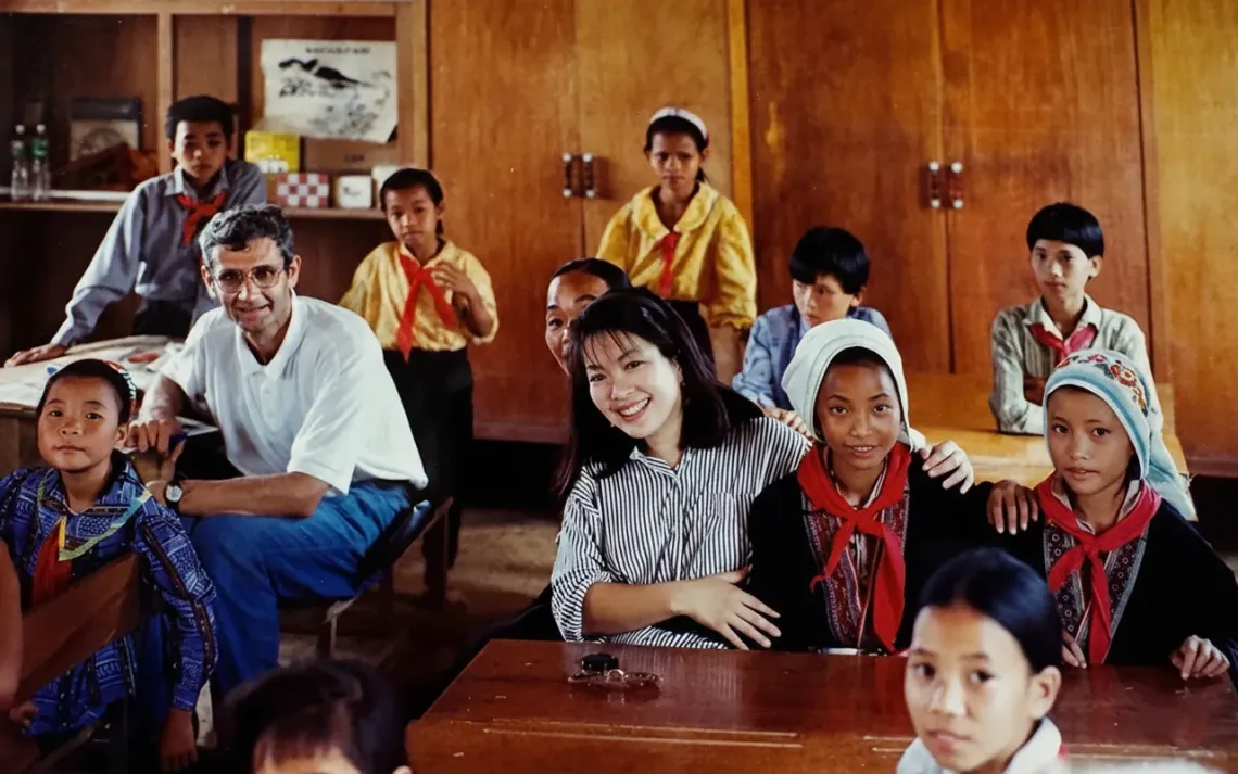 June Kunugi (centre in striped shirt), who was appointed UNICEF Regional Director for East Asia and the Pacific in July 2024, is pictured during a visit to Hoa Binh province (now Phu Tho province) in 1994, when she was serving in Viet Nam as a UNICEF Communications Junior Professional Officer. 