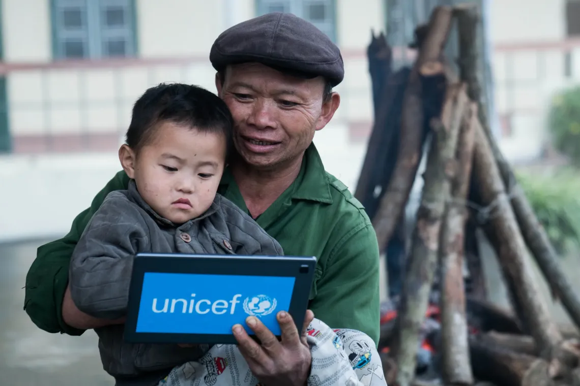 Giang A Sang and his grandfather Giang A Seng in Lao Cai experiencing Augmented and Virtual Reality (AVR) technology introduced by UNICEF in 2020.  
