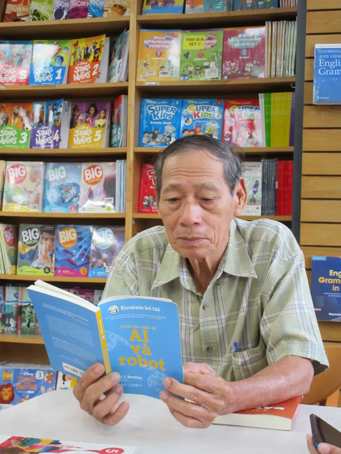 An old man reading a book titled AI & robots
