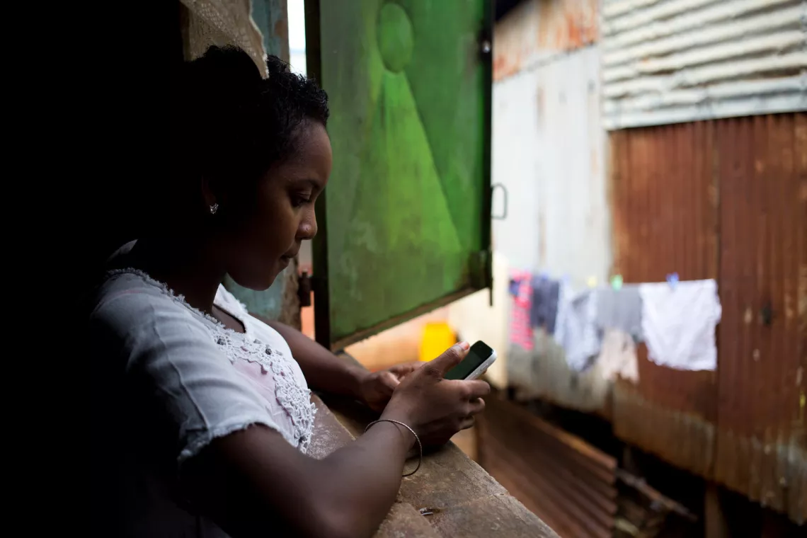 16-year-old Charmela accesses the Internet on her mobile phone, in her home on the island of Nosy Be, off the northwest coast of Madagascar.