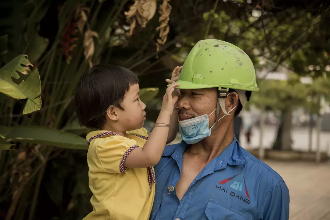 Nguyen Van Hung, 40, and his daughter, Nguyen Thi Tien at the Little Sun Kinder Garten at the Pou Yuen Factory Compound, Ho Chi Minh City. 