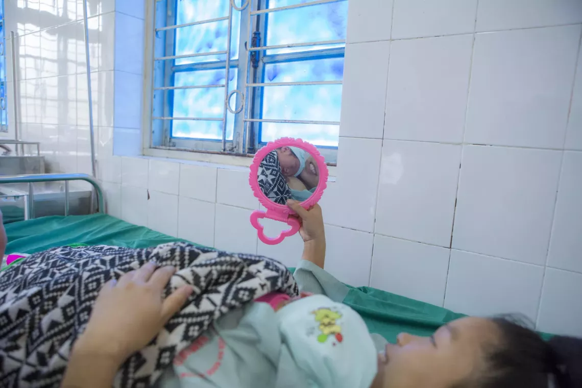 A mother is doing kangaroo care with her child