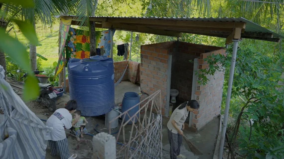 The family&rsquo;s new toilet was built next to their home with support from emergency cash assistance, giving Bi and her siblings a safer, cleaner and more private place to use every day.