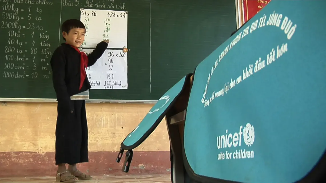 Mang, a 9-year-old Mong student, solves math problems in Tau&rsquo;s bilingual class in Lao Chai Primary school in 2012.