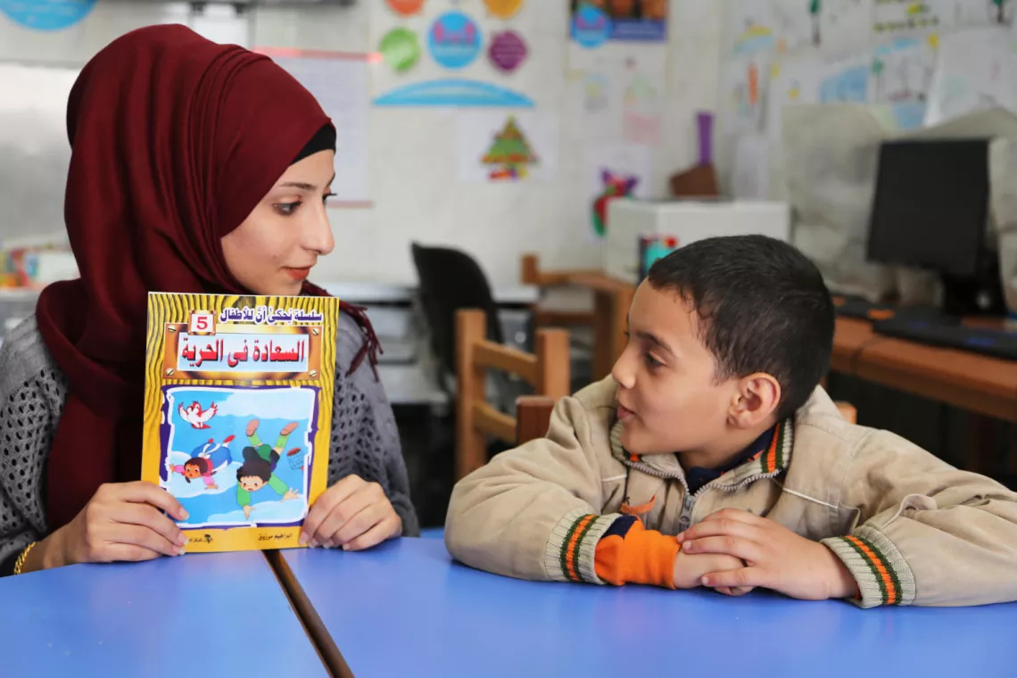 Rawan Nabulsi, 21, who had to leave her home in Syria at age 15, helps children coping with the hard time, trauma and negative feelings she went through when she was their age. 