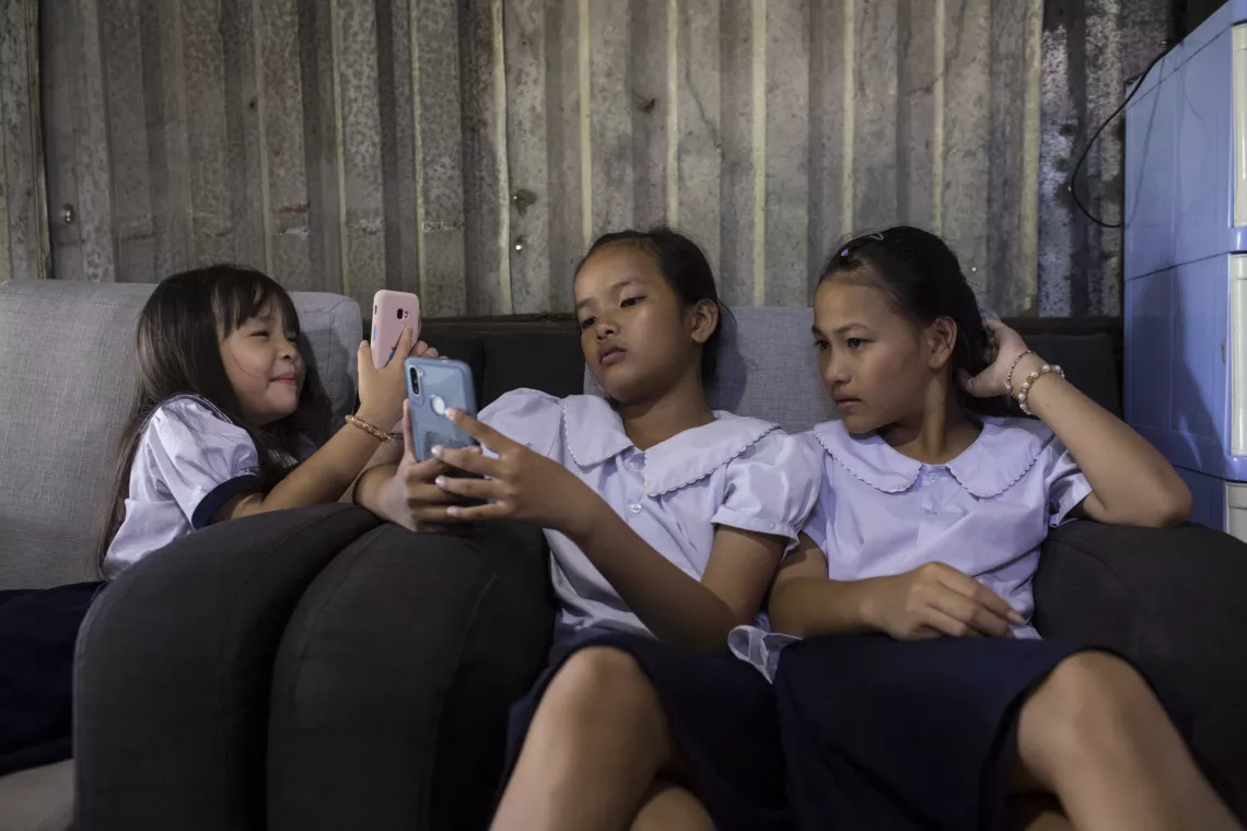 Vo Thi Thu Ngan (right) spends time after school with her best friend, Pham Thach Kim Quyen and her younger sister