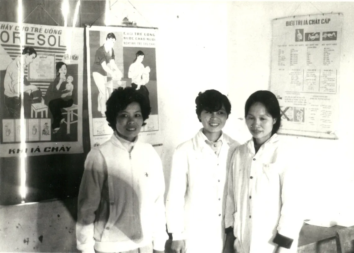 UNICEF-supported campaign posters on treatment of diarrhoeal diseases serve as a backdrop in 1994 to health workers at Minh Bao Commune Health Centre, in northern Yen Bai province (now Lao Cai province)