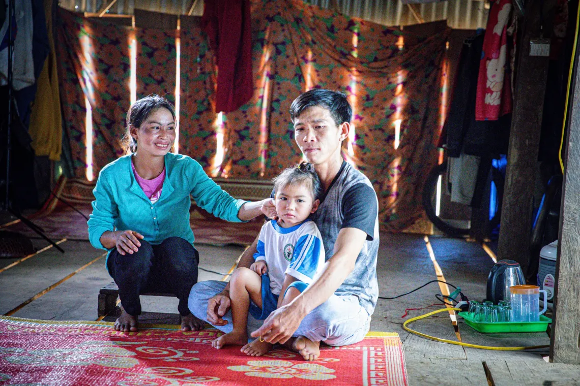 Ly Thuy Trang, pictured with her father Thang and mother Tay at their home in Kret Kot village, in central Gia Lai province in 2024. 