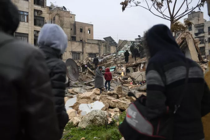 Syria. People gather around collapsed buildings as rescue teams look for survivors following an earthquake.