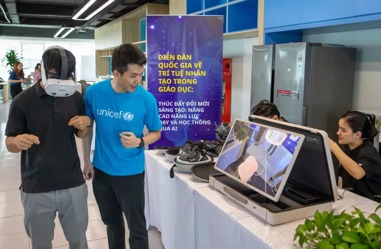UNICEF staff and workshop participants explore virtual reality glasses &ndash; a high-tech educational tool showcased at the event.