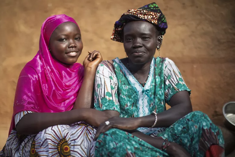 15-year-old Hawa sits with her mother Fatimata Bah.Photo taken In the village of Gourel-Ceno-Dedji, located in the Kayes region, Mali, in October 2024.