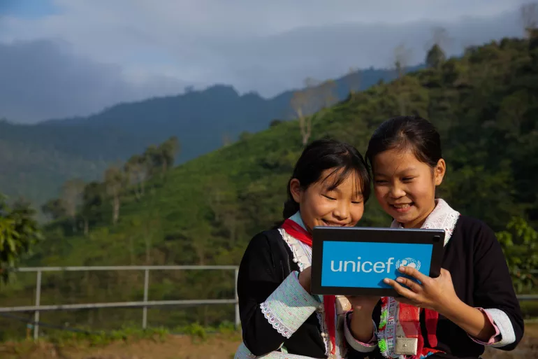 Tan Thanh Hien (left) 11 years old and her friend Tan Thi Hang (right) 11 years old, were trying the AR technology on the tablet supported by UNICEF at Bat Xat secondary high school in Lao Cai.