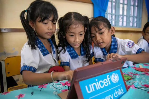 Ba trẻ em g&aacute;i đang sử dụng m&aacute;y t&iacute;nh bảng t&agrave;i trợ bởi UNICEF