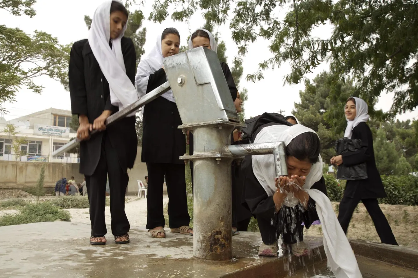 Girl drinks water from a Mark II-type hand pump, at the Sultan Razia Girls' High School, in the city of Mazar-e-Sharif in the northern province of Balkh.