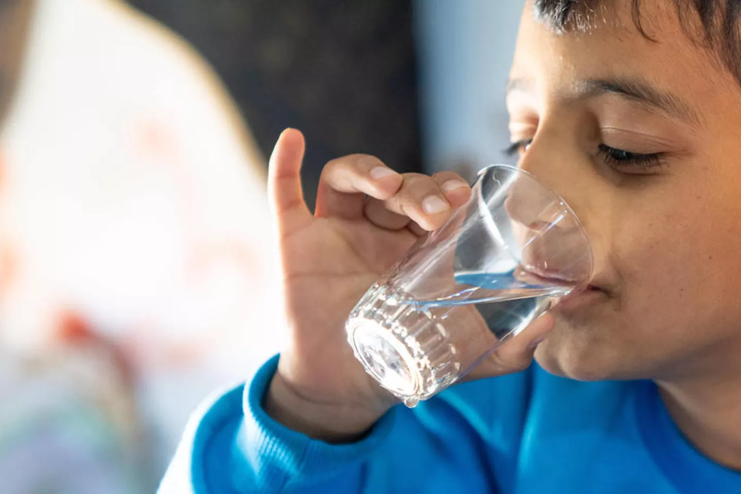 A boy drinking water.