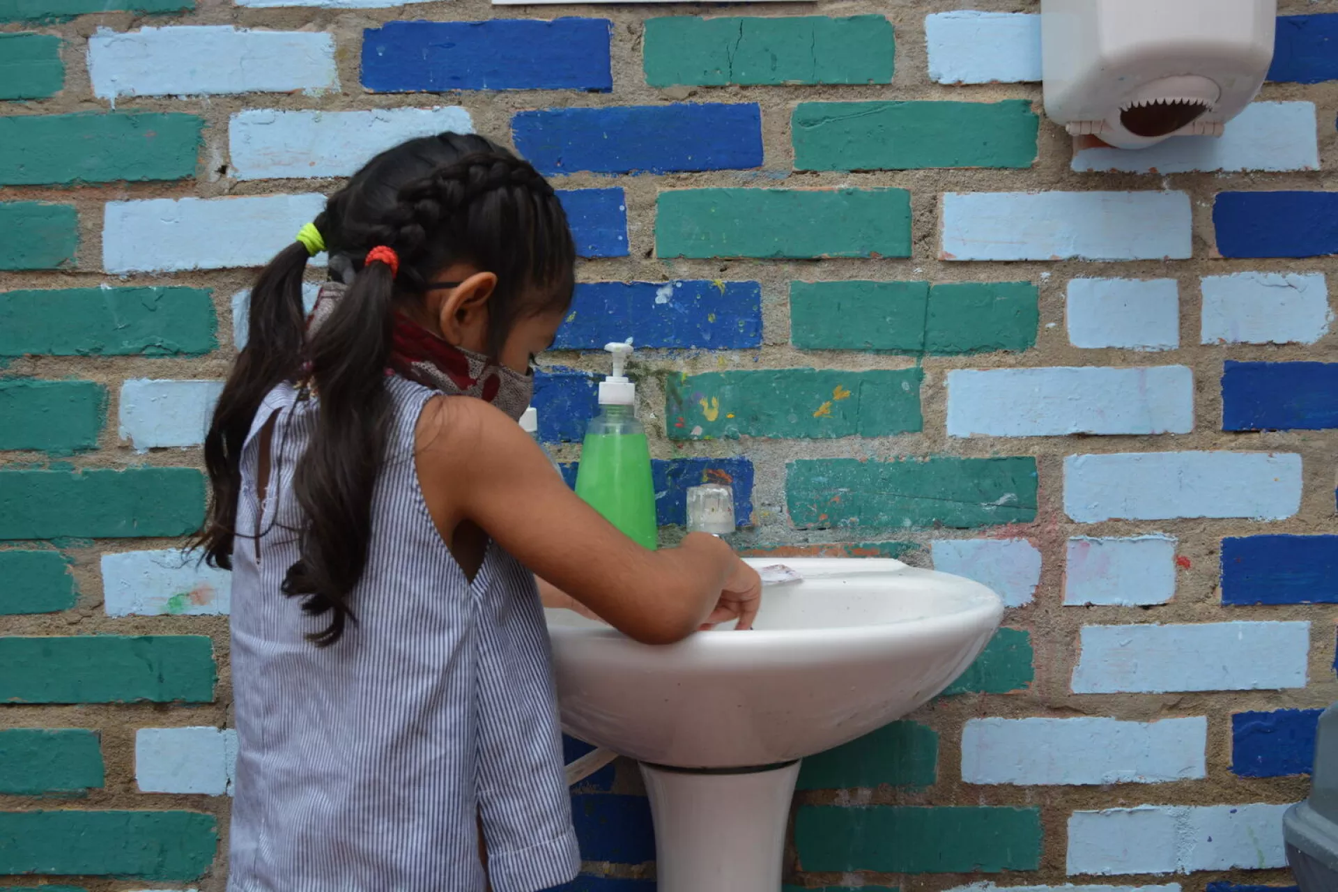 A child washing her hands.