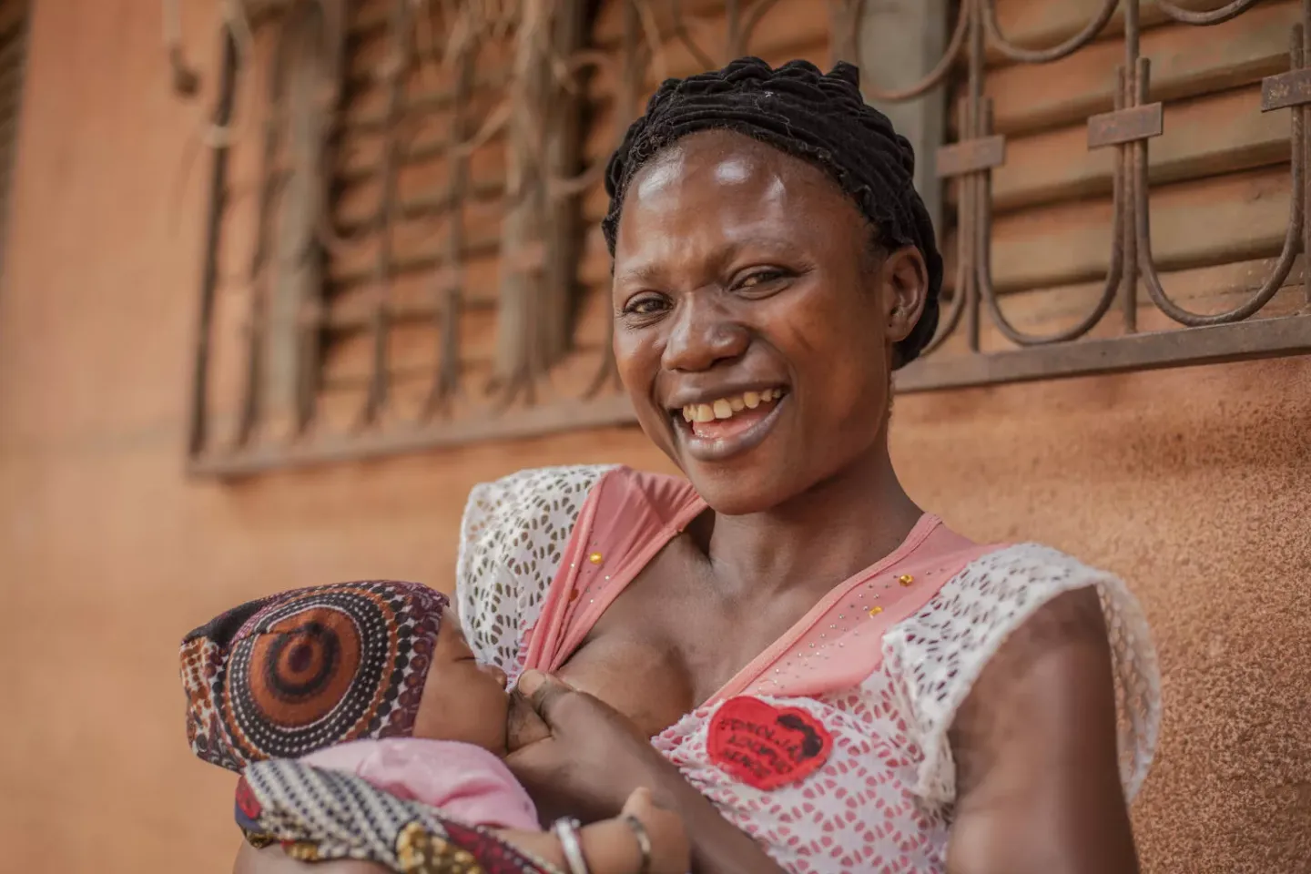 A mother happily breastfeeding her baby