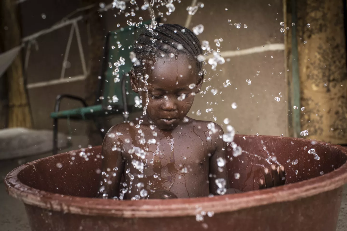 Girl takes a bath in a plastic bathtub